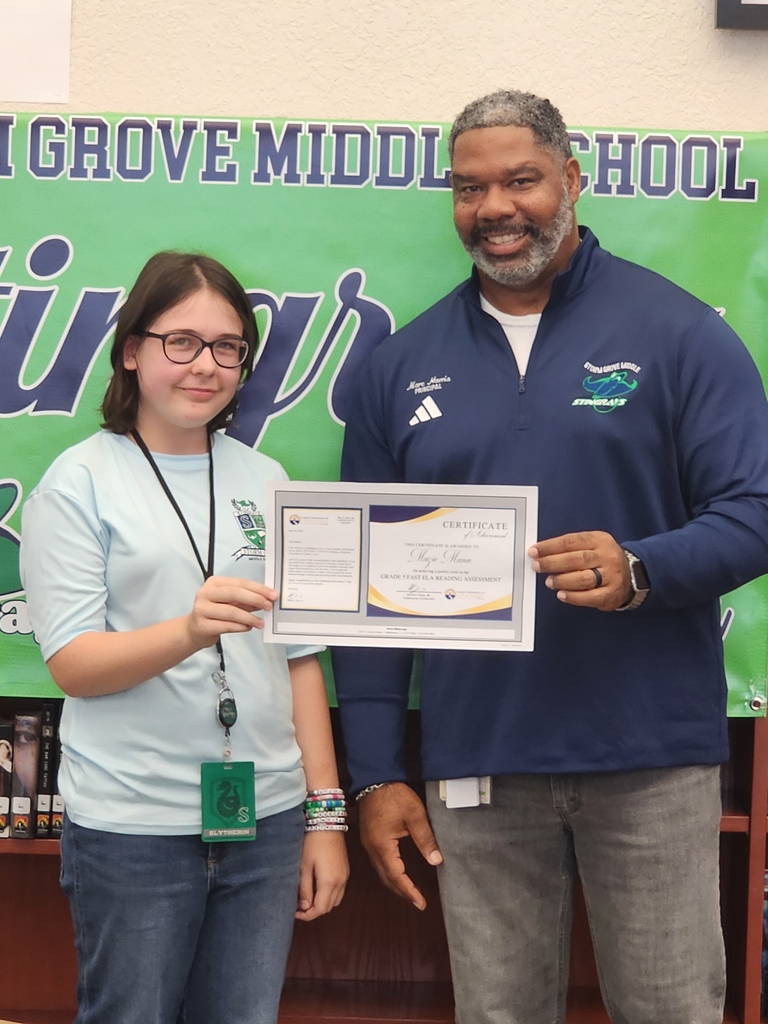 Student and Principal holding award