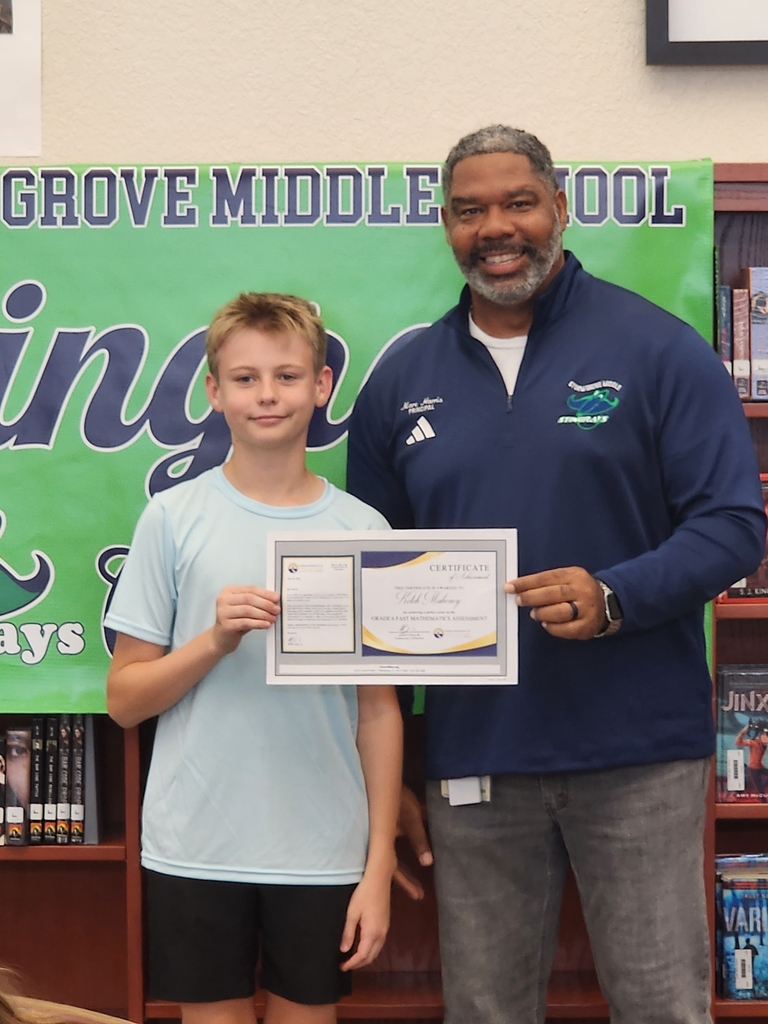 Student and Principal holding award