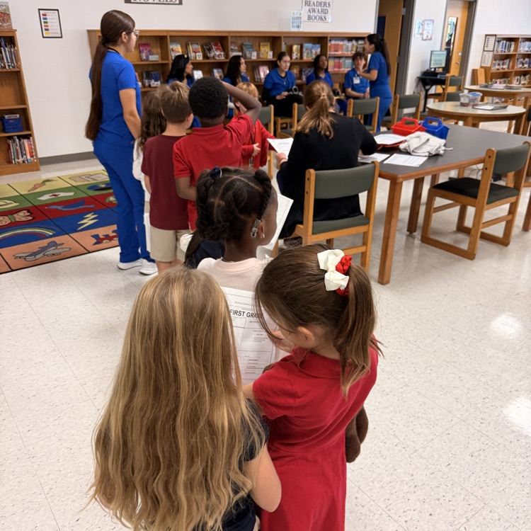 students waiting for health screening