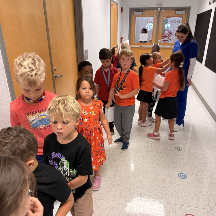 students waiting for health screening