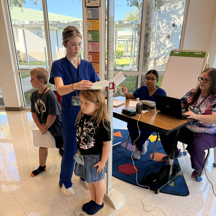 students waiting for health screening