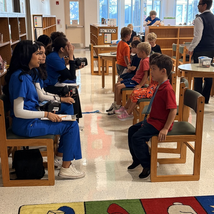 students waiting for health screening