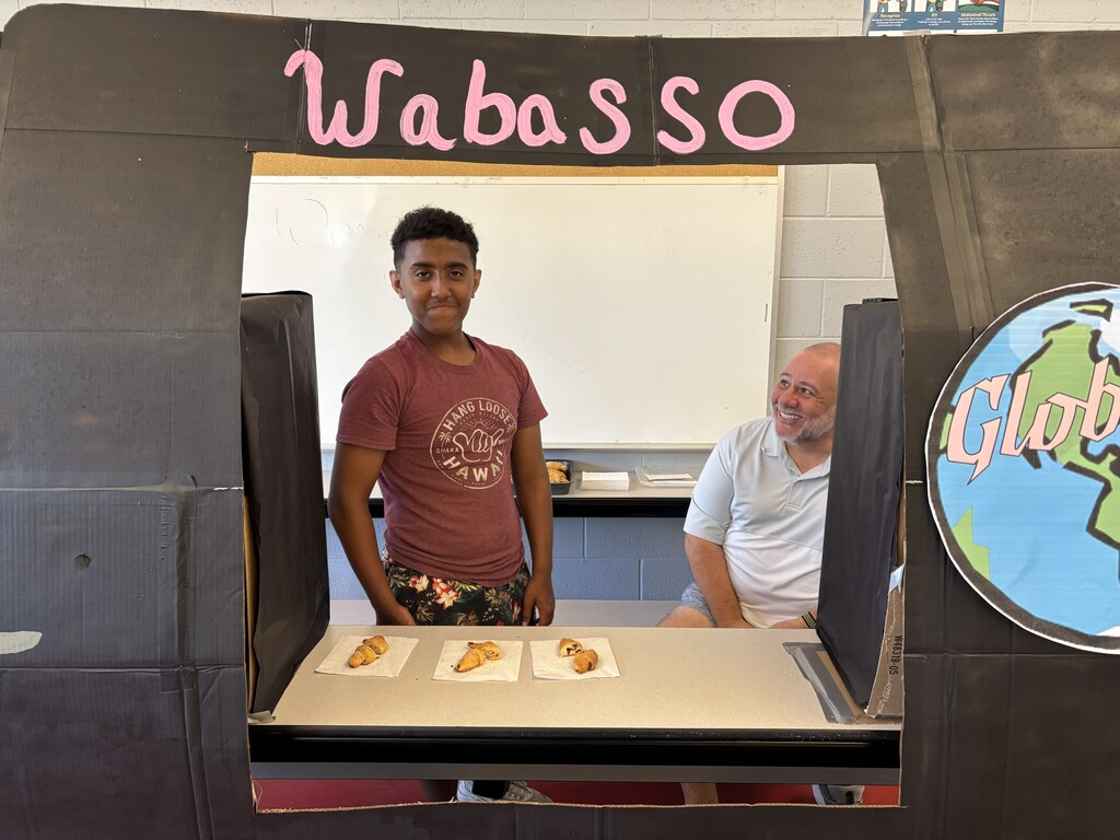 student serving at food truck