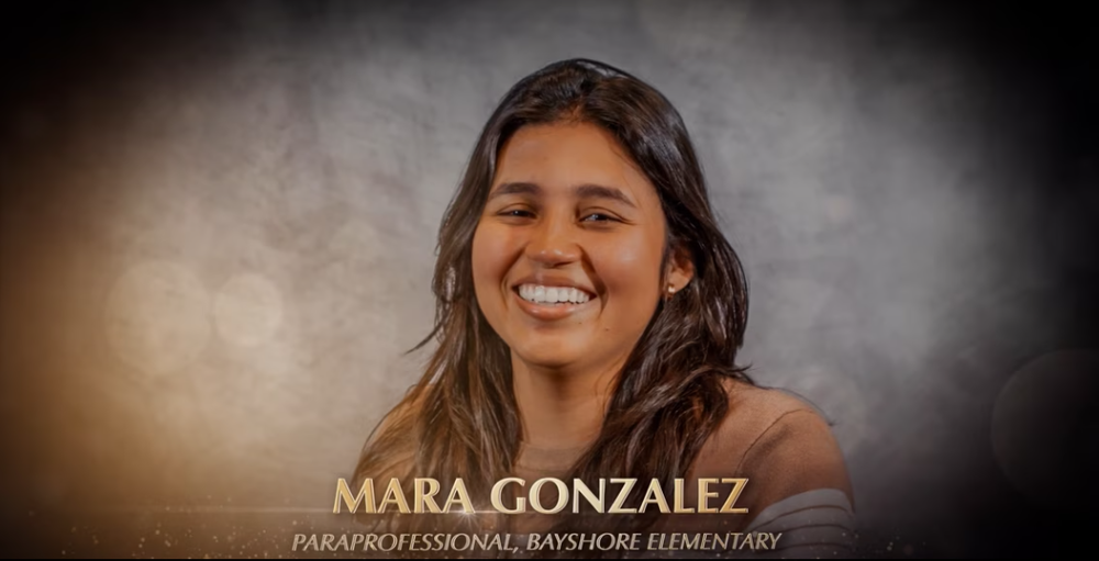 A smiling woman with long dark hair.