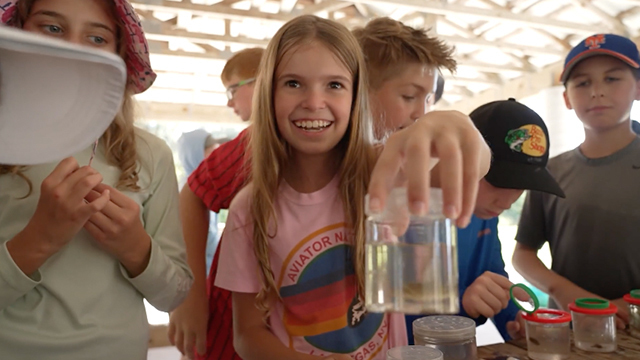 happy children learning with hands-on marine science