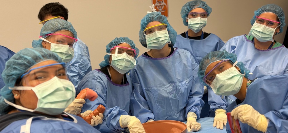 Students wearing scrubs and masks.