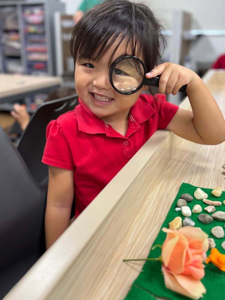 student with a magnifying glass