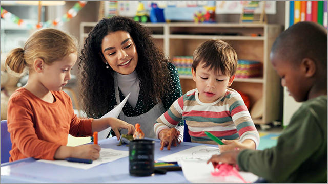 teacher helps students in the classroom