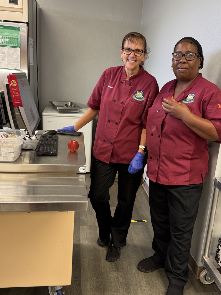 Two food service workers wearing red