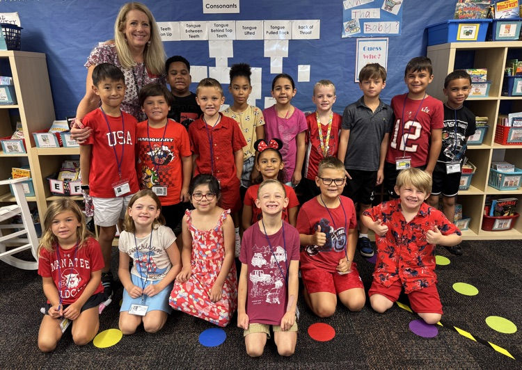 A class of kindergarten students and their teacher all wearing red