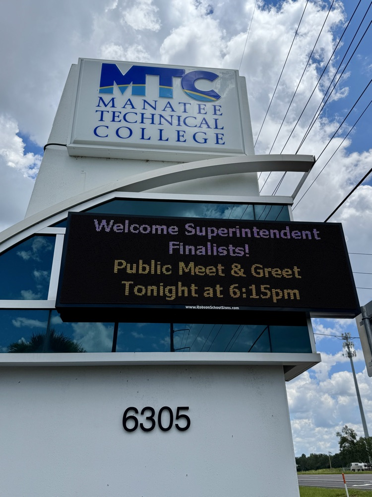 A sign at a school advertising a public event to meet school superintendent finalist