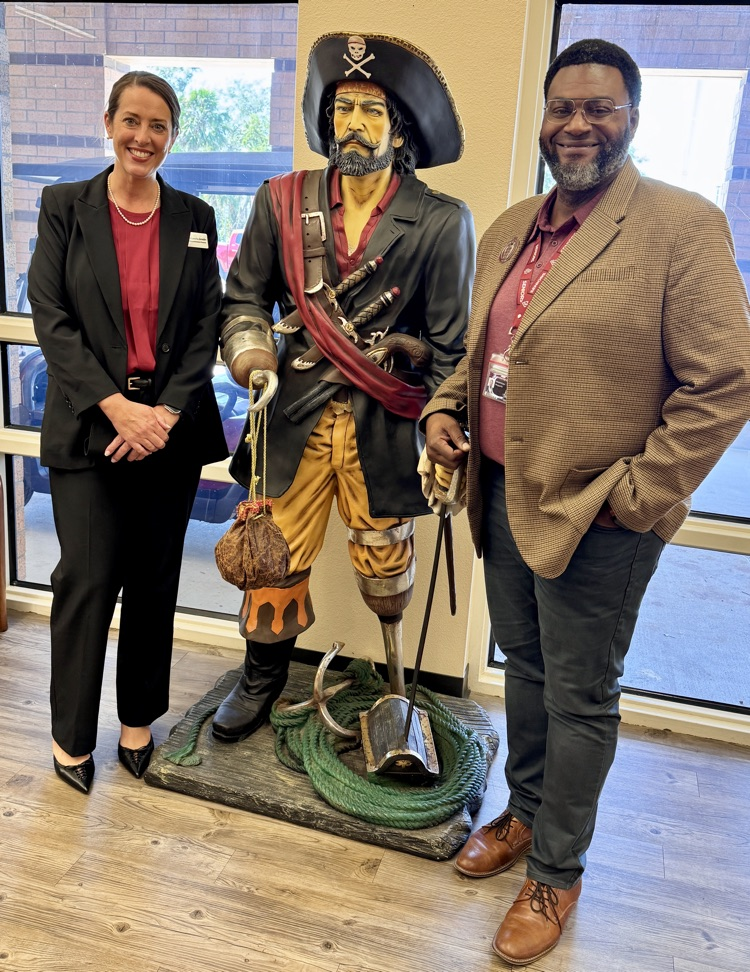 Dr. Laurie Breslin and principal Wendell Butler with a statue of a pirate