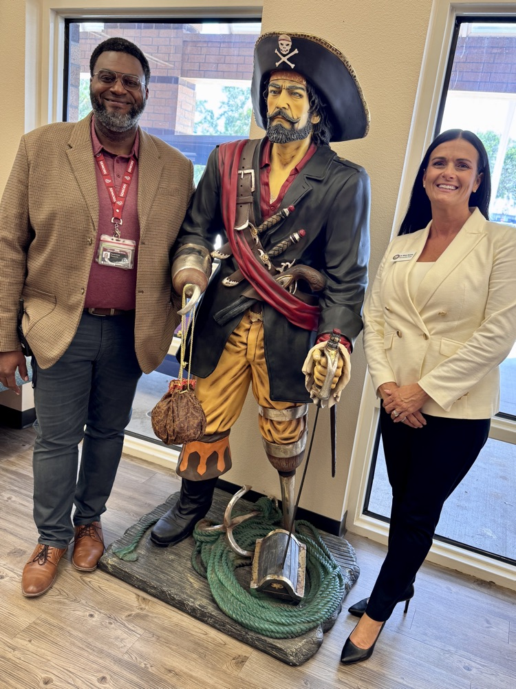 dr. Misty Mathis and principal Wendell Butler at Braden River high school with the statue of a pirate