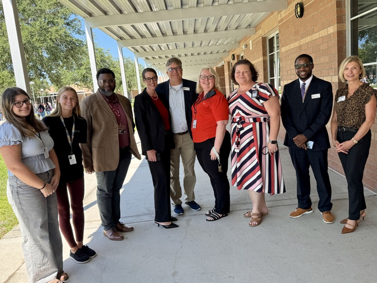 A group of school, district, and community leaders join Dr. Laurie goodBreslin for a tour of Braden River high school