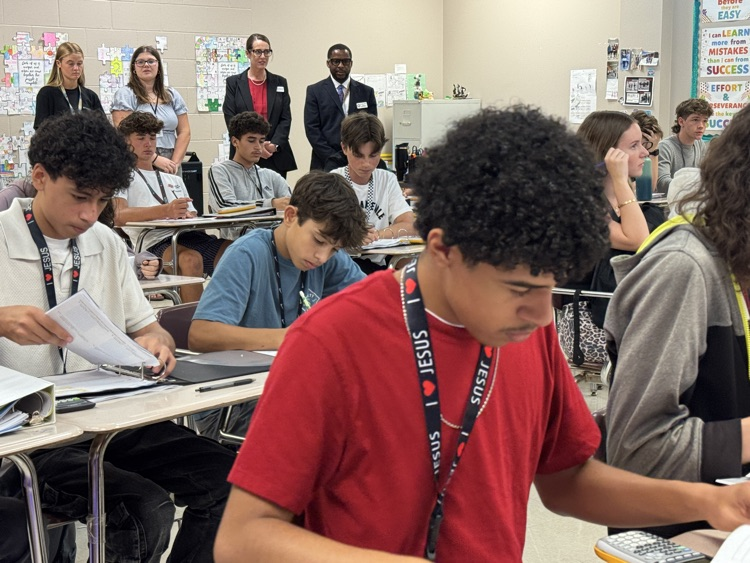 A superintendent finalist looks on inside a classroom