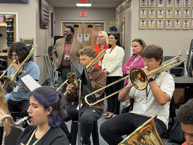 A superintendent finalist looks on inside the band room at a high school
