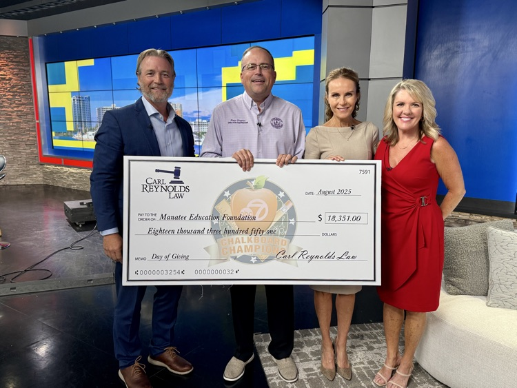 Four people holding a large check made out to the Manatee education foundation