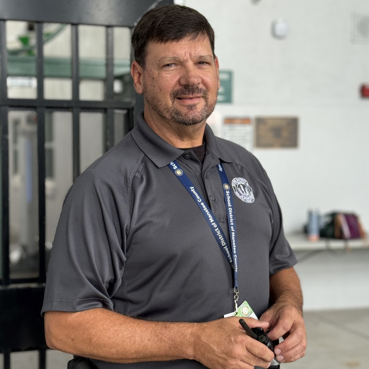 A school guardian holding a walkie-talkie on campus