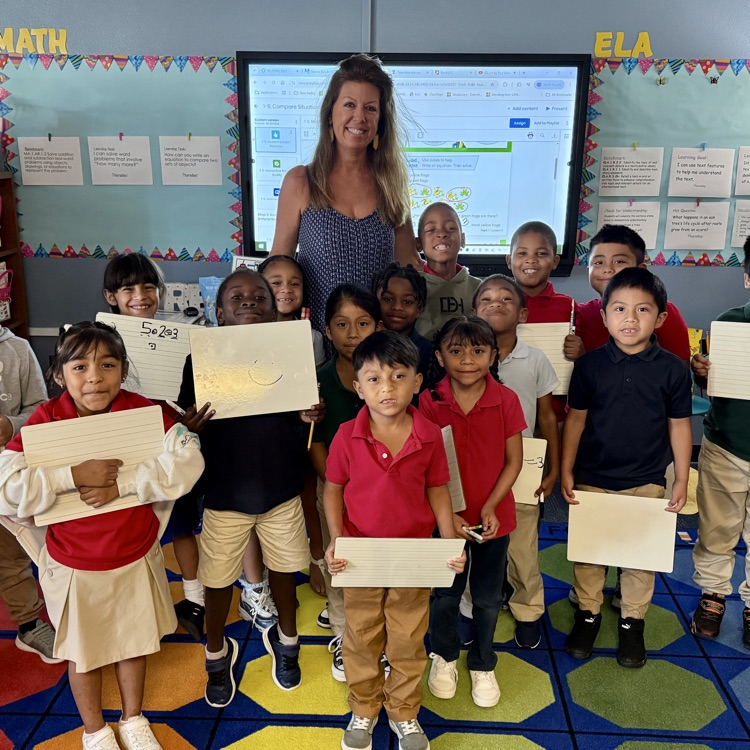 A class photo with a first grade teacher and student students