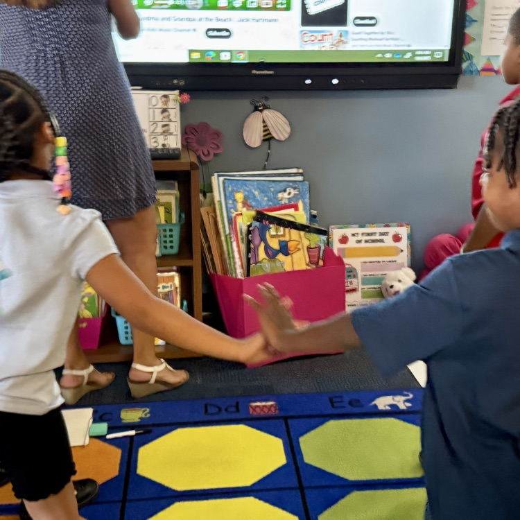 Kids dancing to a video about math equations