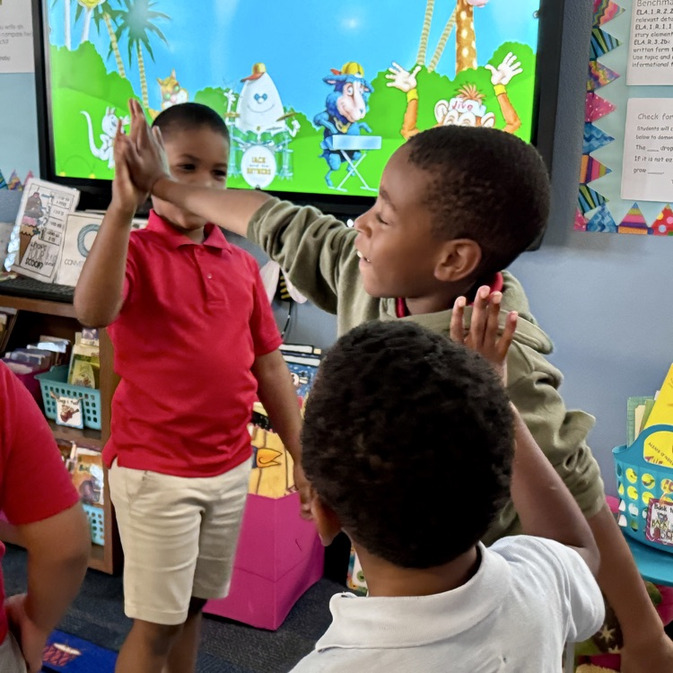 Kids high-fiving one another in celebration