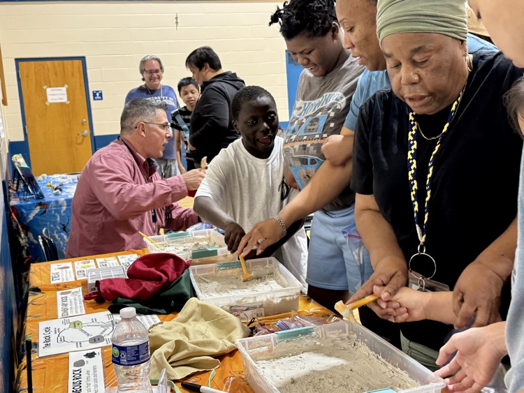 Students participate in a fossil dig at school