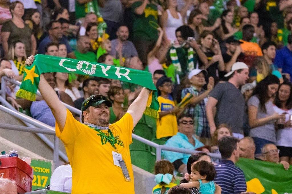 Late teacher Matt Cox (left) holds up a Rowdies scarf in Al Lang Stadium