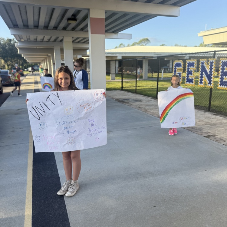 students holding posters are celebrating start with hello week at Witt Elementary