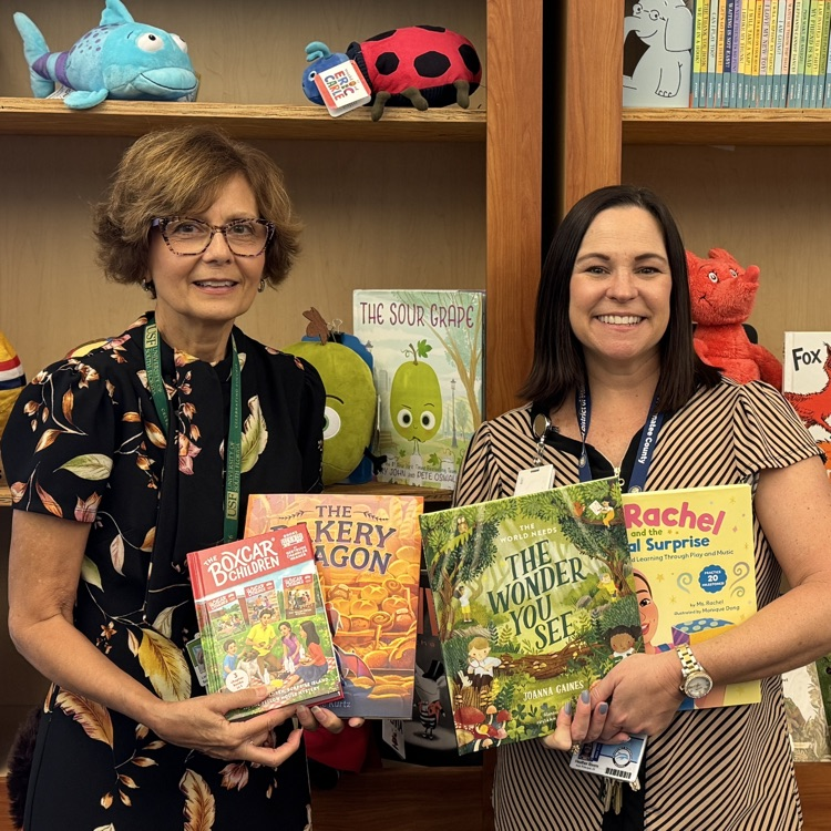 School administrators, holding books and appreciation for the public who donated them