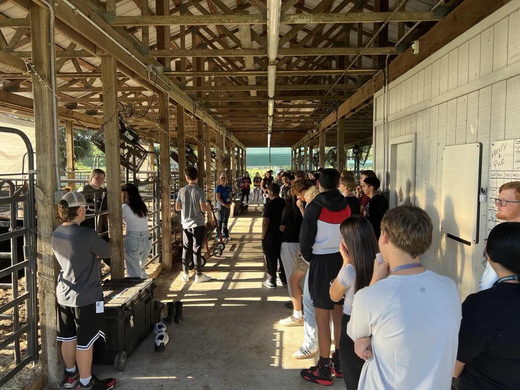 Agriscience students touring a barn or land lab.