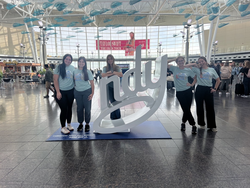 Students standing by a sculpture that reads, "Indy", while traveling to Indiana for a national FFA conference.