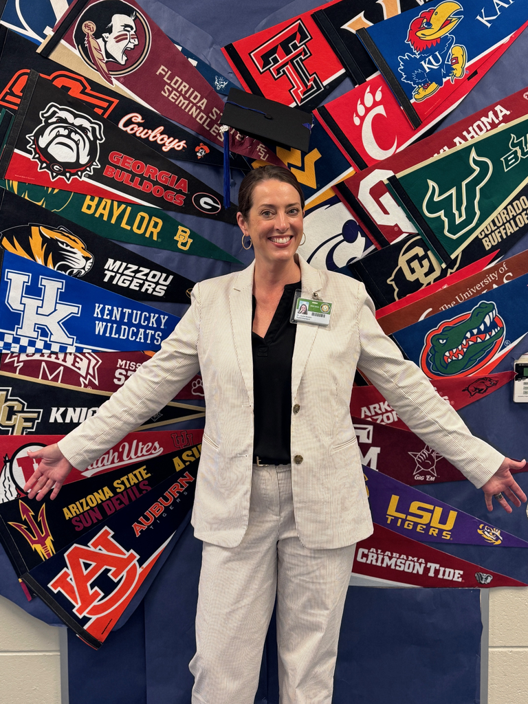 A woman standing in front of college pennants formed as wings.