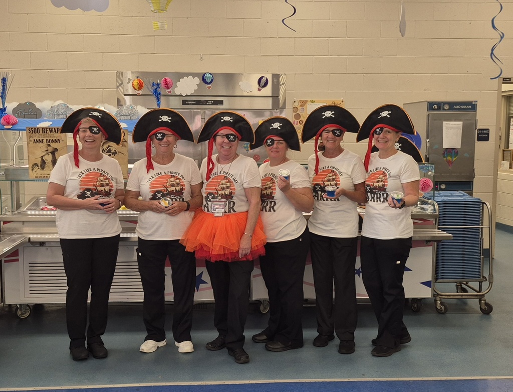 Lunch ladies dressed up like pirates for a school event.