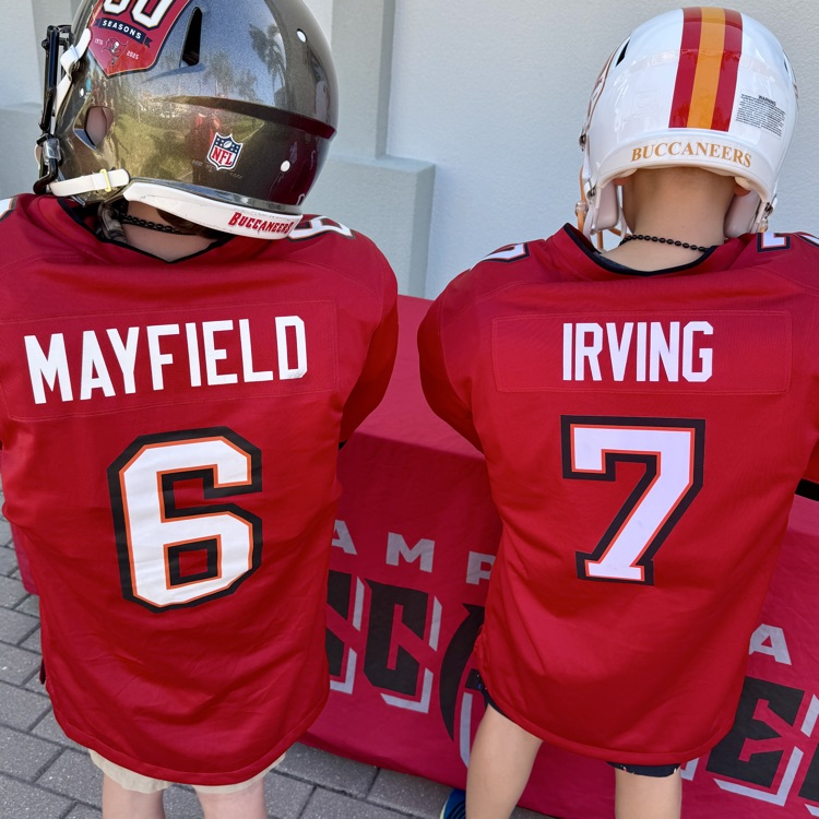 two kids wearing Buccaneers jerseys number six and seven
