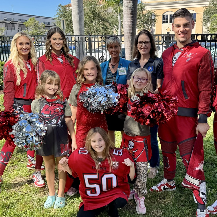students and teachers join Buccaneers cheerleaders at the bishop museum