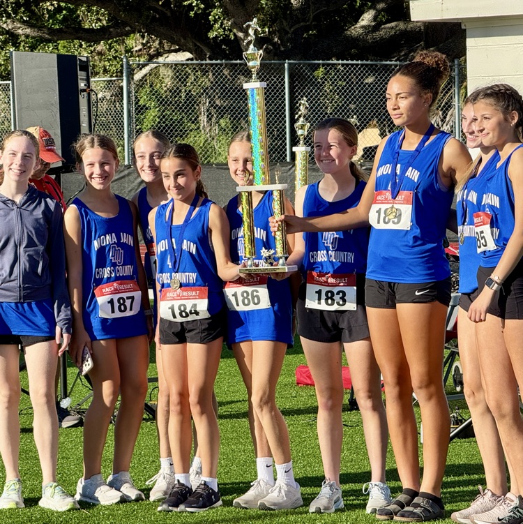 Middle school runners holding up a trophy