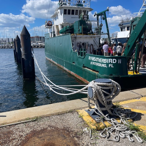 A green ship with the name, Weatherbird on the front