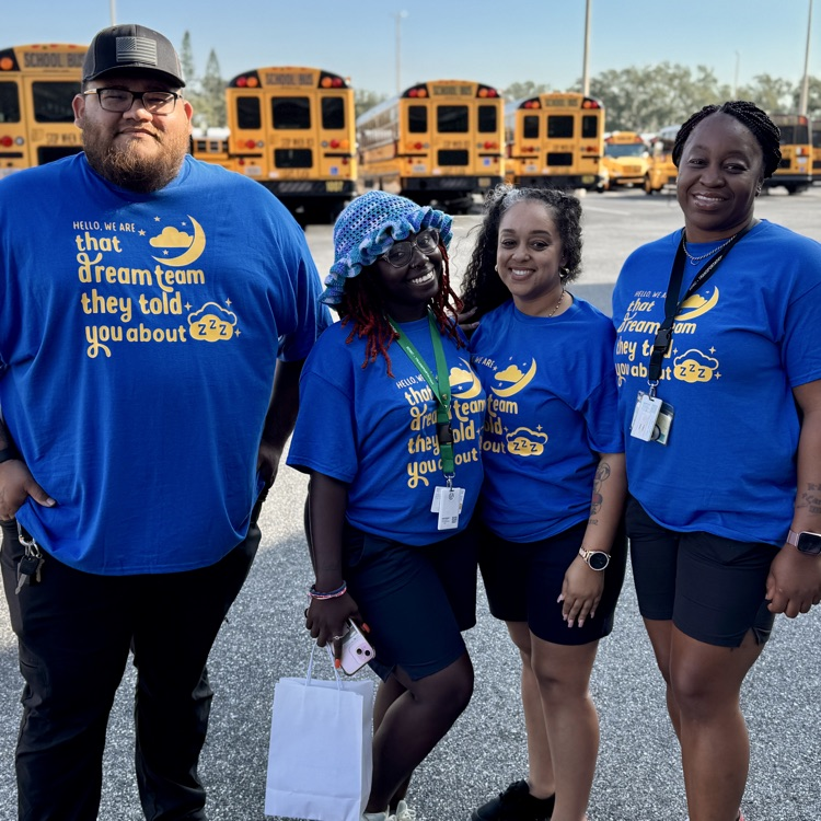 School bus drivers wearing blue shirts, and smiles before the school bus rodeo