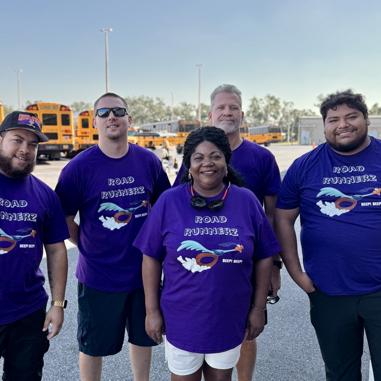 School bus driver is wearing purple roadrunner T-shirts gather as a team before the school bus rodeo
