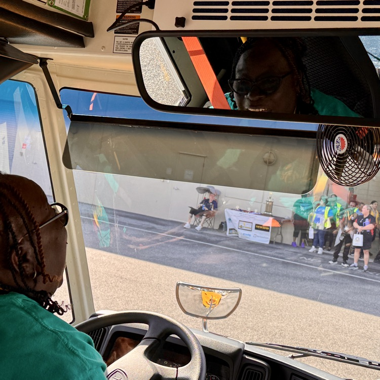 transportation employees look on as their colleagues prepared to takeoff in the school bus rodeo