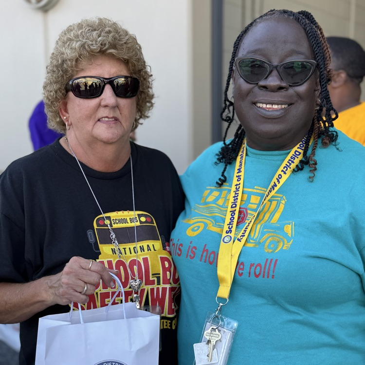 District employees supporting their peers during the school bus radio while wearing T-shirts