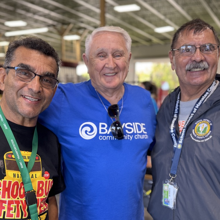two transportation employees in a church volunteer, smiling