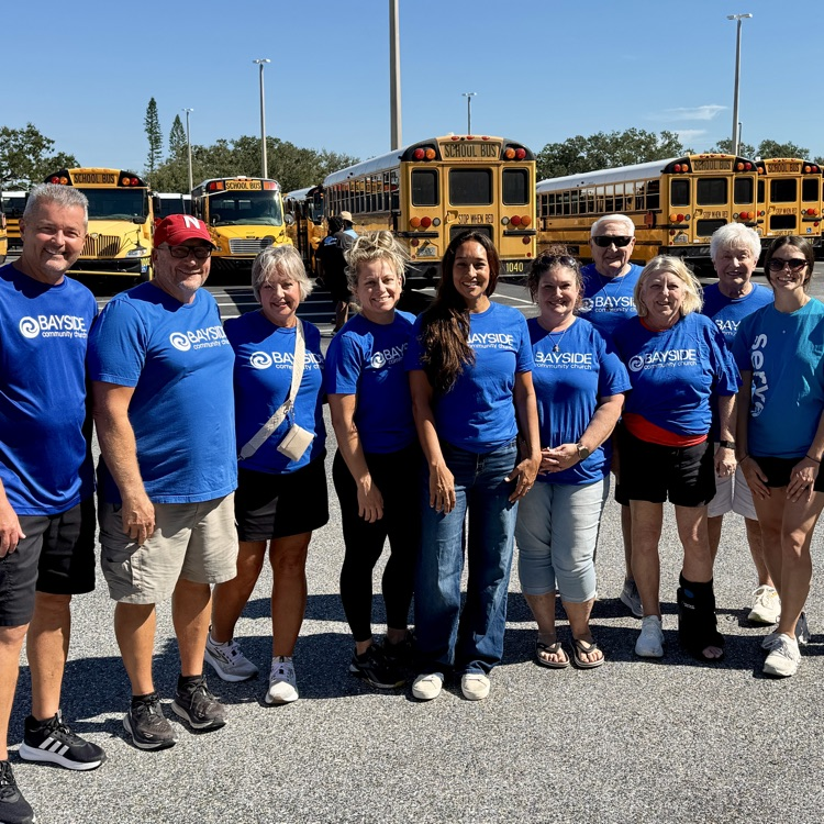 Church volunteers standing at the Matzke complex in front of where the school buses are located