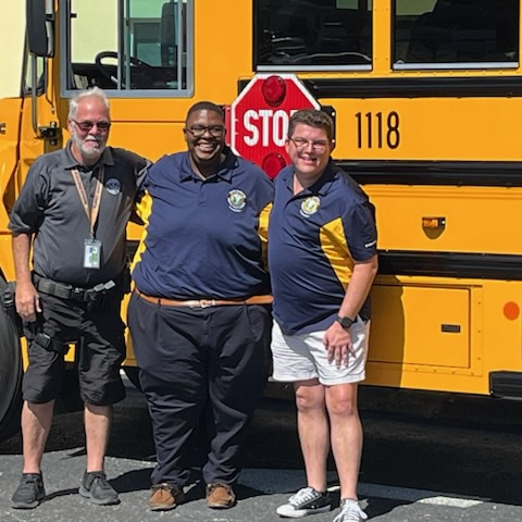two bus drivers in the school, safety guardian with a new bus that was on display at The Soar Lab