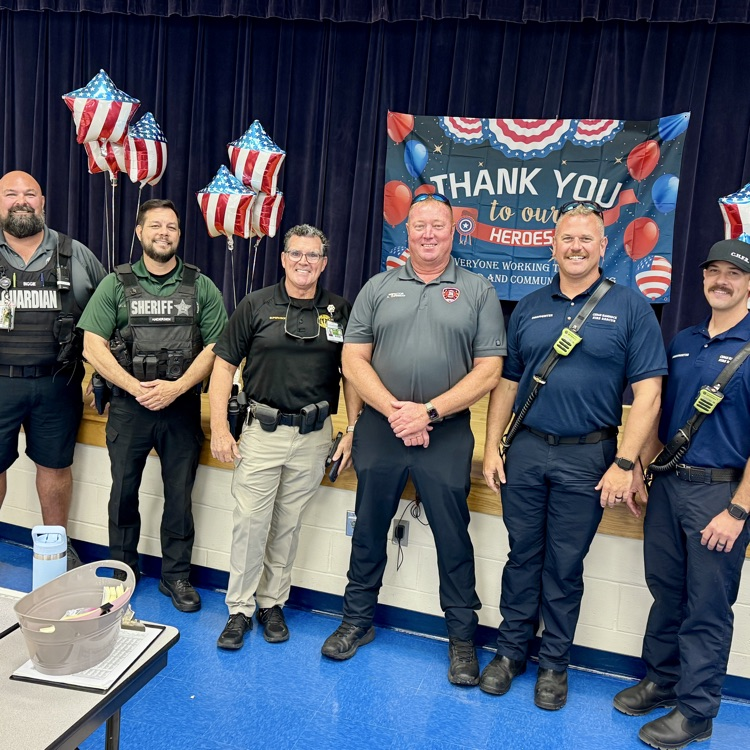 first responder standing shoulder to shoulder and Prine Elementary’s cafeteria 
