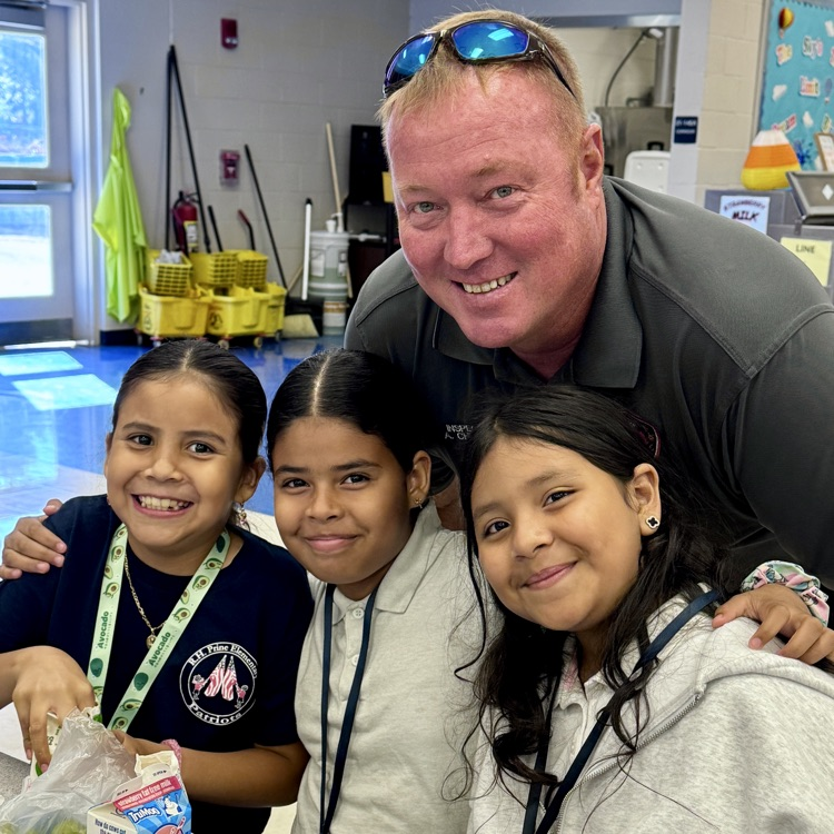 A member of Cedar hammock, fire rescue, smiles with students