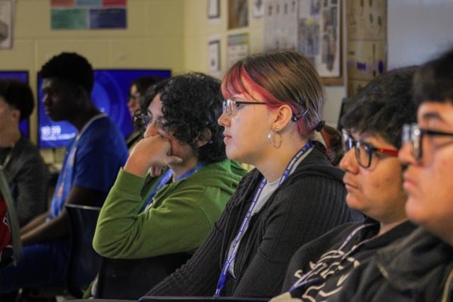 Students listening to a  guest speaker in class.