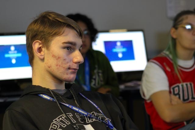 Students in a journalism class listen to a guest speaker in class.