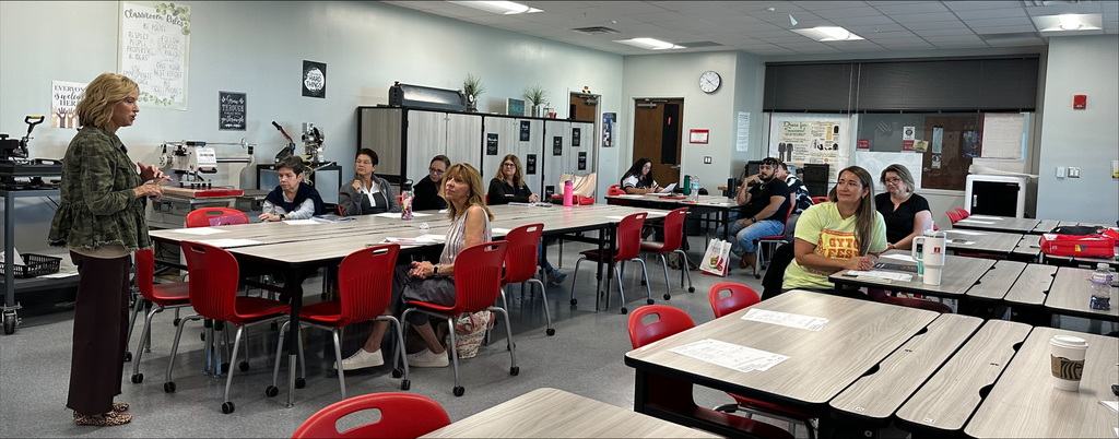 Teachers listen to a speaker during a professional development event.