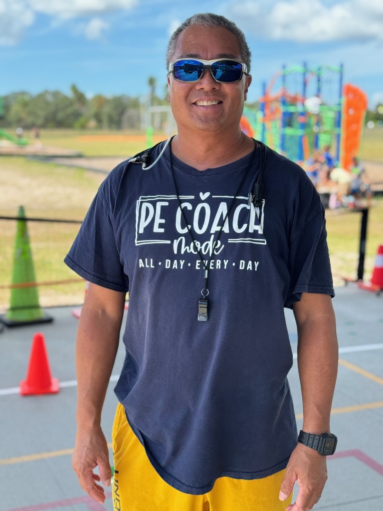 A PE coach wearing a blue shirt which reads, "PE Coach Mode: All Day Every Day"